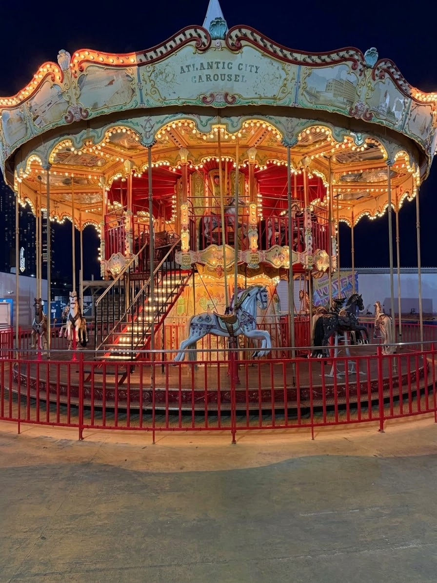 A brightly lit vintage carousel at night